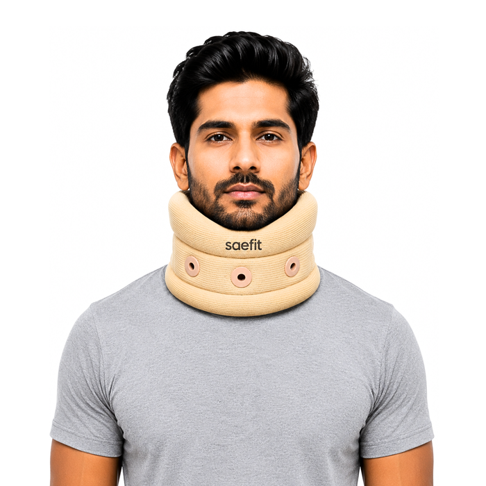 A man wearing a beige saefit neck support collar over a gray t-shirt, shown against a plain white background.